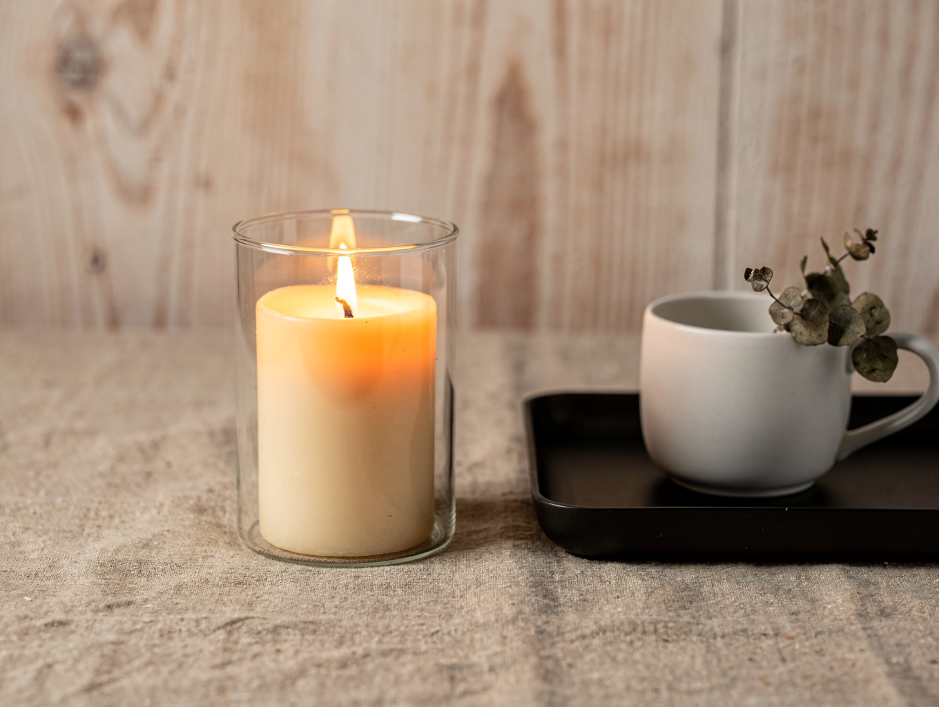 A single candle flame in a dark, quiet room